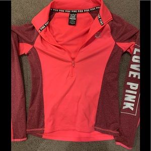 Pink bundle top has a zipped pocket on back